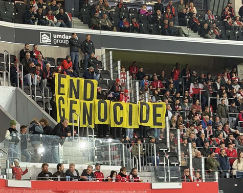 Amnesty International displays “end genocide” banner at Austria vs. Israel UNL match